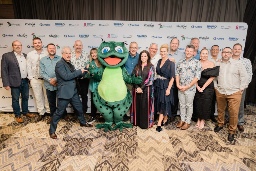 Group of Megasealed employees standing with mascot during National conference